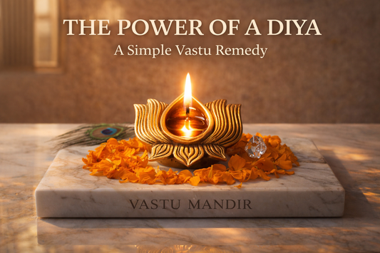 Scene: white marble slab with “Vastu Mandir” engraving  Objects: • brass diya lit in center • soft marigold petals around • peacock feather placed subtly • small crystal beside diya  Background: luxury modern Indian interior with warm textured wall