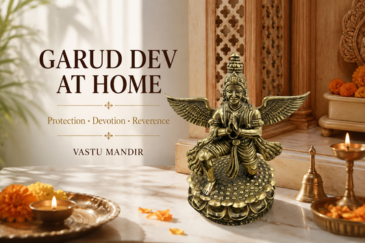 Brass Garud Dev idol with diya, bell, flowers, and clean sacred tray in a Vastu-aligned Indian home mandir.