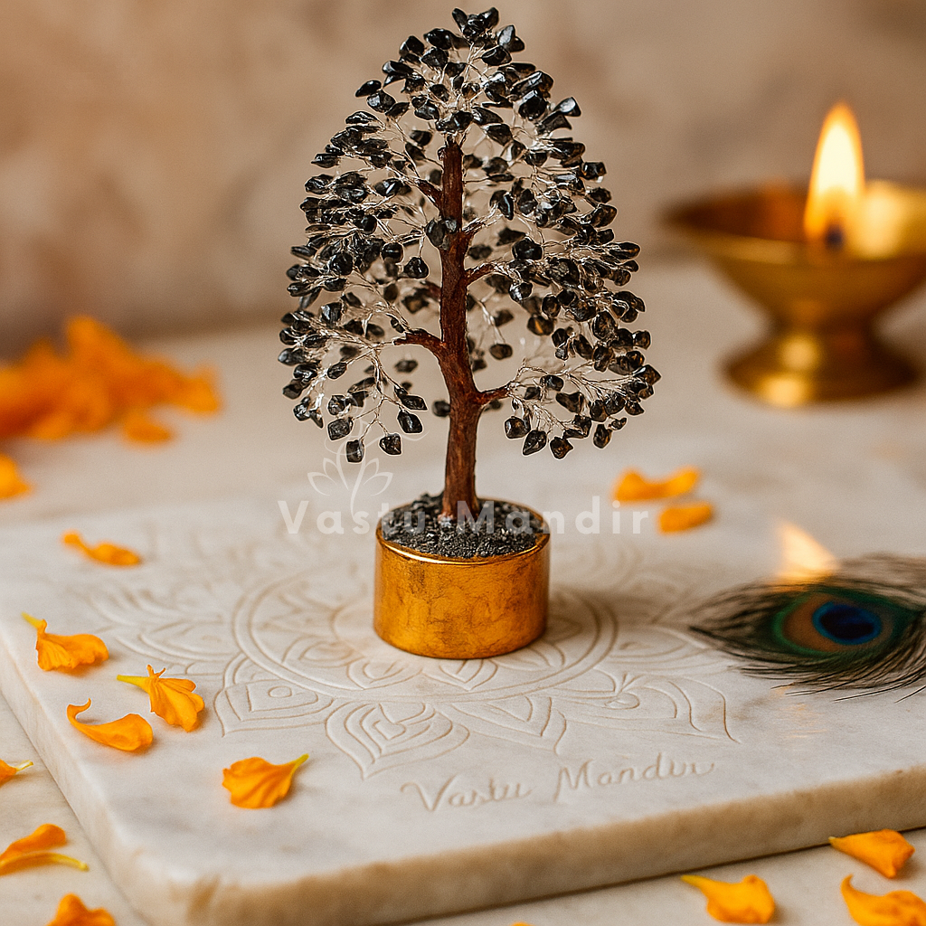 Black Tourmaline Vastu Tree (10-11 Inch) for protection, grounding, and negative energy absorption, on a marble surface with flowers and a candle.
