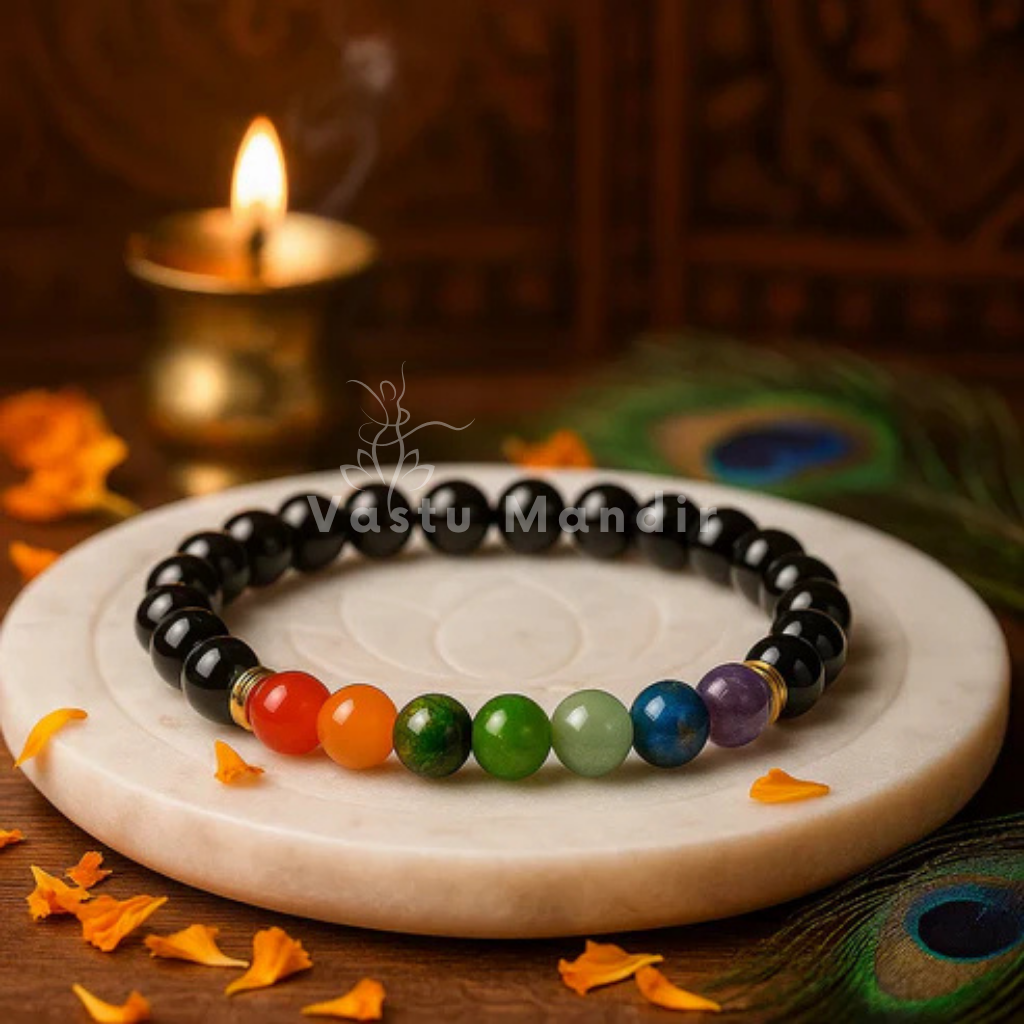 Chakra beaded bracelet on a marble surface with a candle in the background