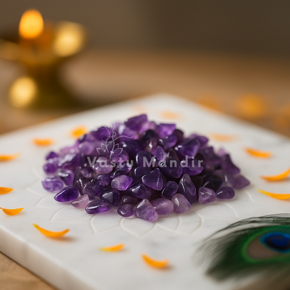 Purple Amethyst crystal chips on a white plate with decorative elements, featuring 'Vastu Mandir' branding.