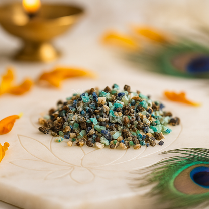 Small pile of Azurite stones on a decorative surface with peacock feathers and a candle.