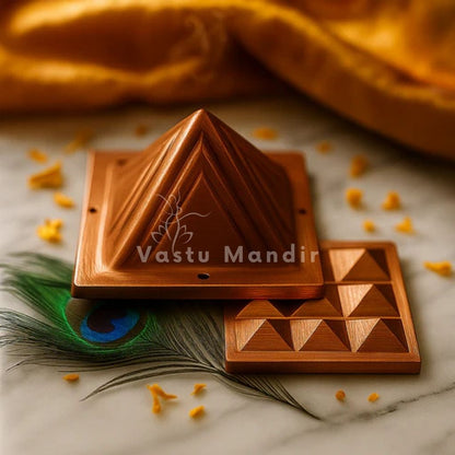 2-Layer Copper Vastu Pyramid with 'Vastu Mandir' branding on a marble surface with peacock feather.