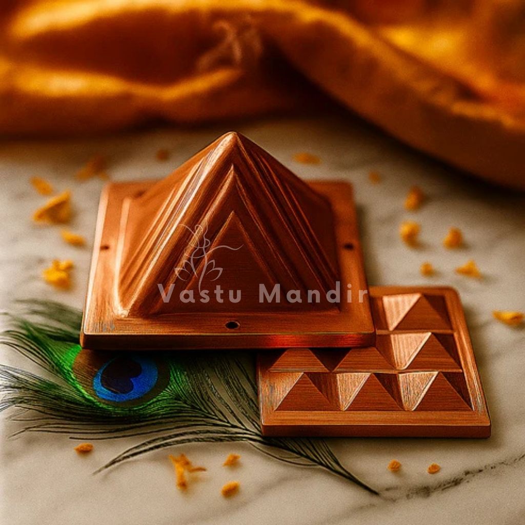 2-Layer Copper Vastu Pyramid with 'Vastu Mandir' branding on a textured surface with peacock feather.