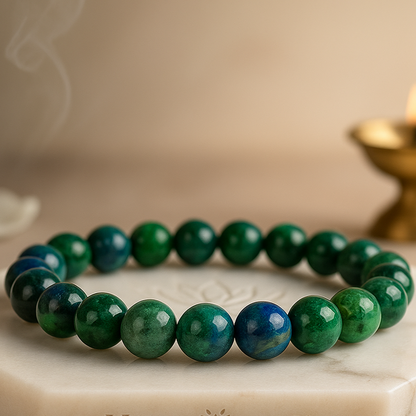 Azurite 8mm bead bracelet with deep blue-green mottling on elastic cord.