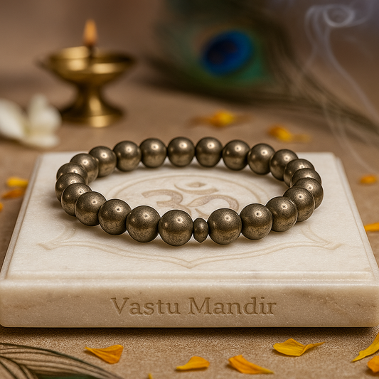 pyrite 8mm bead bracelet on a marble surface with 'Vastu Mandir' branding, surrounded by decorative elements.
