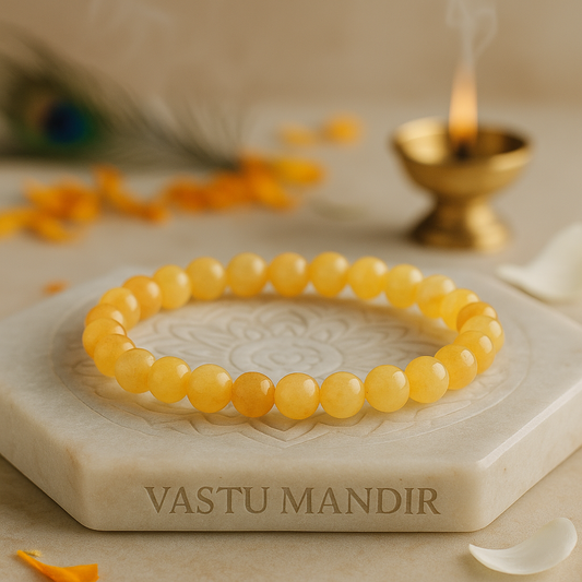 Rutile quartz 8mm bead bracelet on a stone surface with 'Vastu Mandir' branding, surrounded by decorative elements.