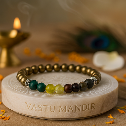 Original pyrite crystal bracelet metallic stone for wealth attraction on a stone platter with 'Vastu Mandir' branding, surrounded by decorative elements.