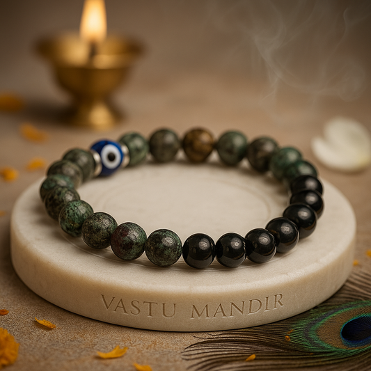 libra zodiac bracelet 8mm with a blue evil eye bead on a stone surface with 'Vastu Mandir' branding, candles, and peacock feather in the background.