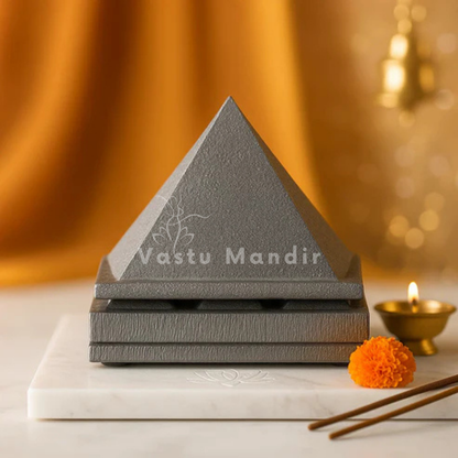 3-Layer Lead Metal Pyramid |with 'Vastu Mandir' branding on a marble surface with decorative elements.