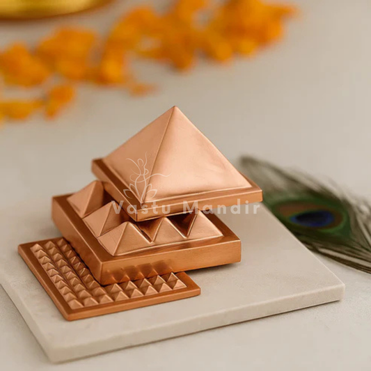 3 layered Copper pyramid on a light surface with decorative elements in the background