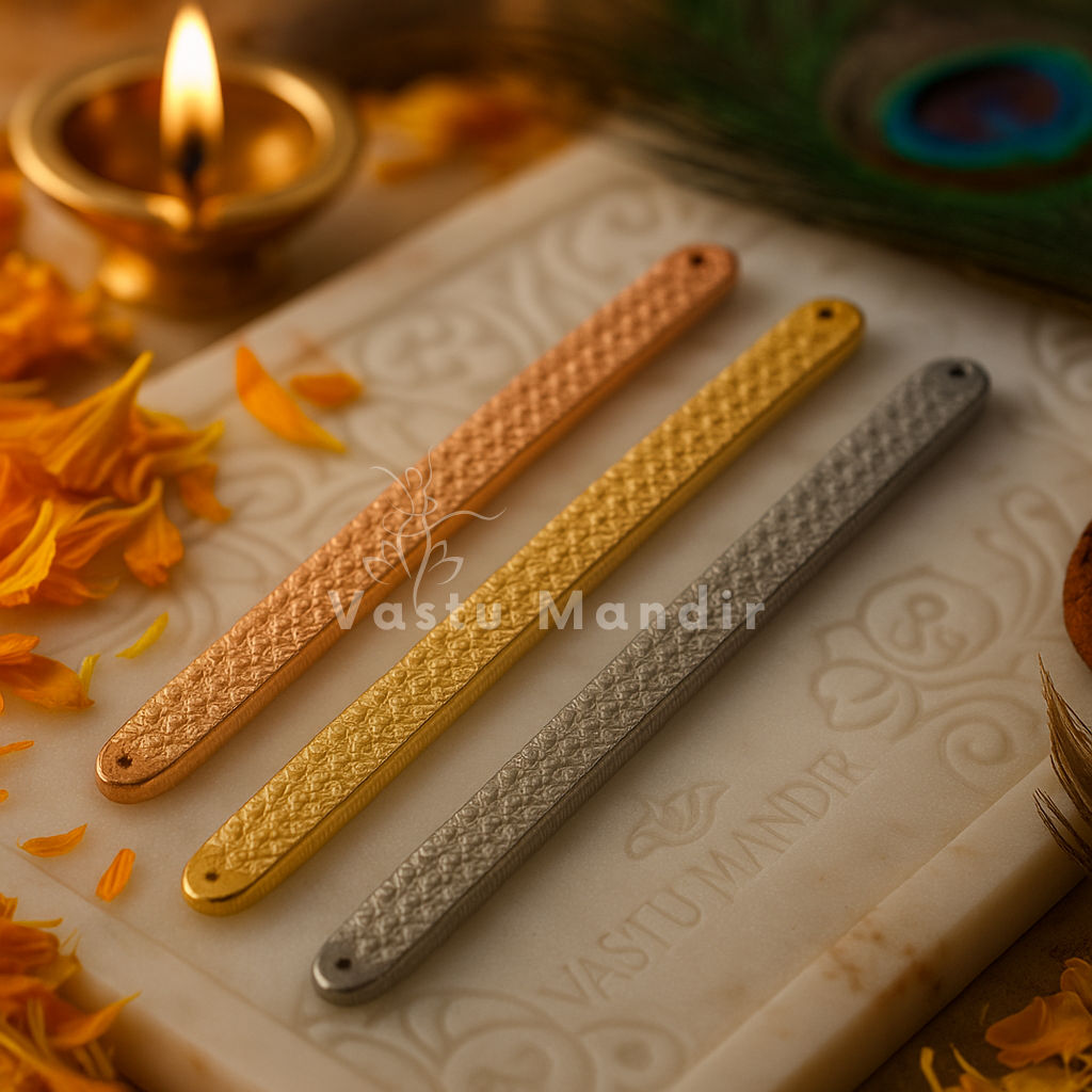 Pyramid Strip 10.5" for Vastu Remedy in Copper, Brass, and Lead on a textured surface with floral elements and a lit candle.