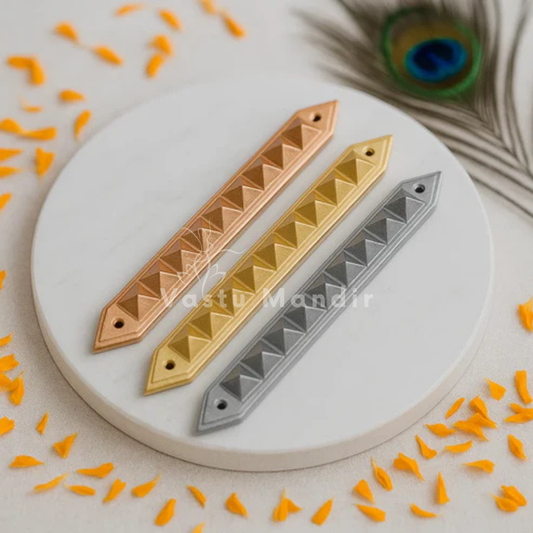 Three metallic bar accessories in Copper, brass, and Lead on a white surface with orange decorative elements.