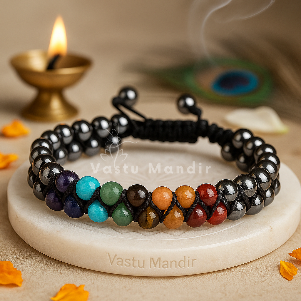 100% Natural Seven Chakra stones (Red Jasper, Carnelian, Citrine, Green Aventurine, Sodalite, Amethyst, Clear Quartz) + High-Grade Hematite beads in double layer design on a white stand with 'Vastu Mandir' branding, surrounded by decorative elements.