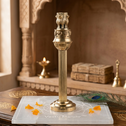 Brass Ashoka Pillar Idol with intricate designs and a warm background.