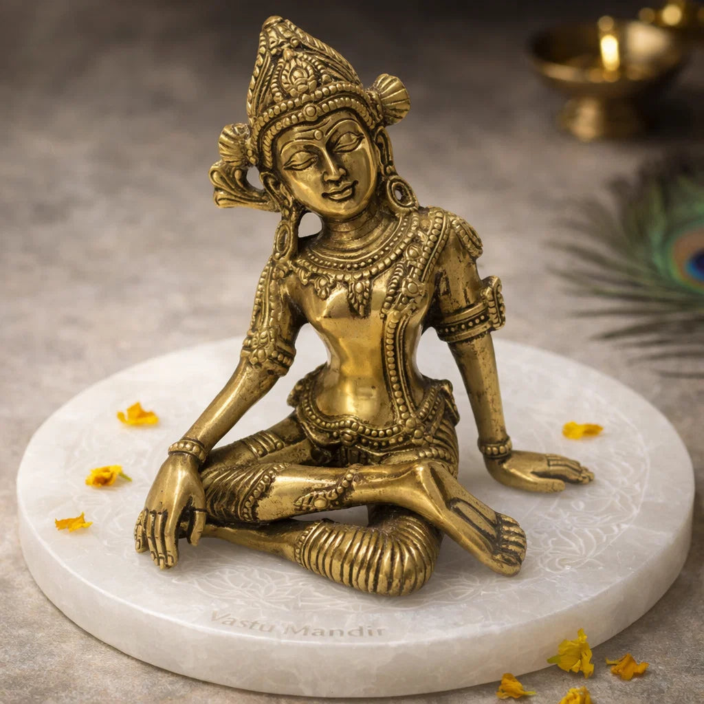 Brass Indra Dev Idol on a marble base with decorative elements.