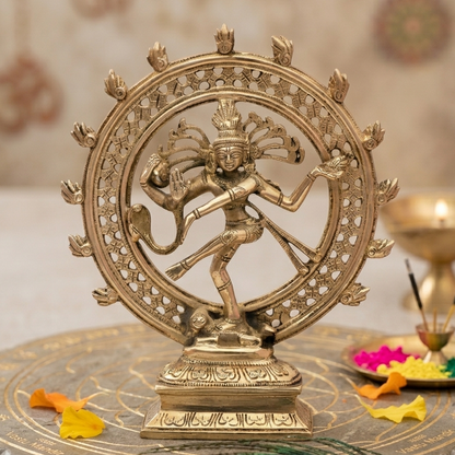 Brass Nataraja Idol with a circular design on a decorative surface.