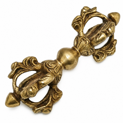 Brass Vajra Dorje with intricate designs on a white background