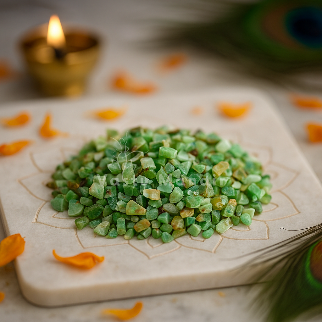 Chrysoprase Crystal Chips on a decorative plate with a candle and peacock feather in the background