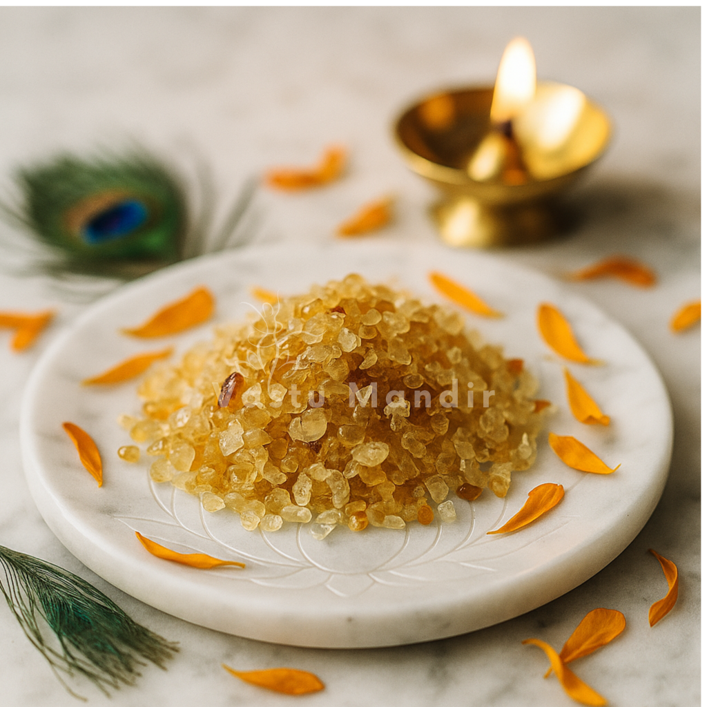 Marble plate with Citrine Crystal Chips, surrounded by orange petals and a lit candle, on a light background.