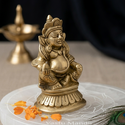 Dhanpati - Lord of Treasure on a white plate with a blurred background