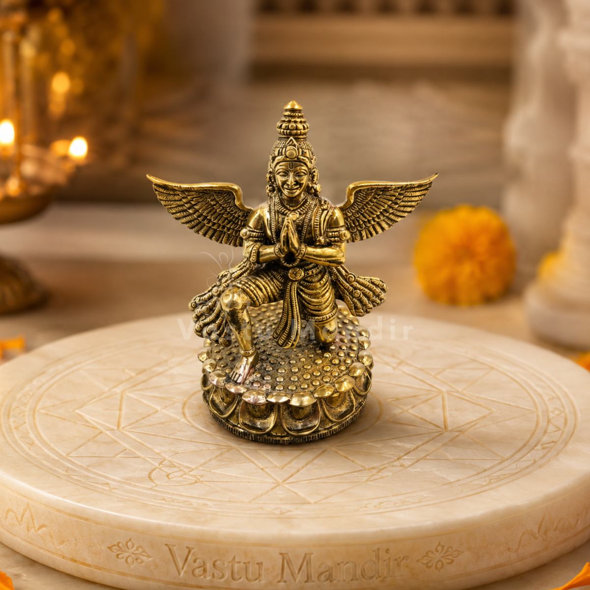Garud Dev brass idol on a circular stone platform with Vastu Mandir engraving