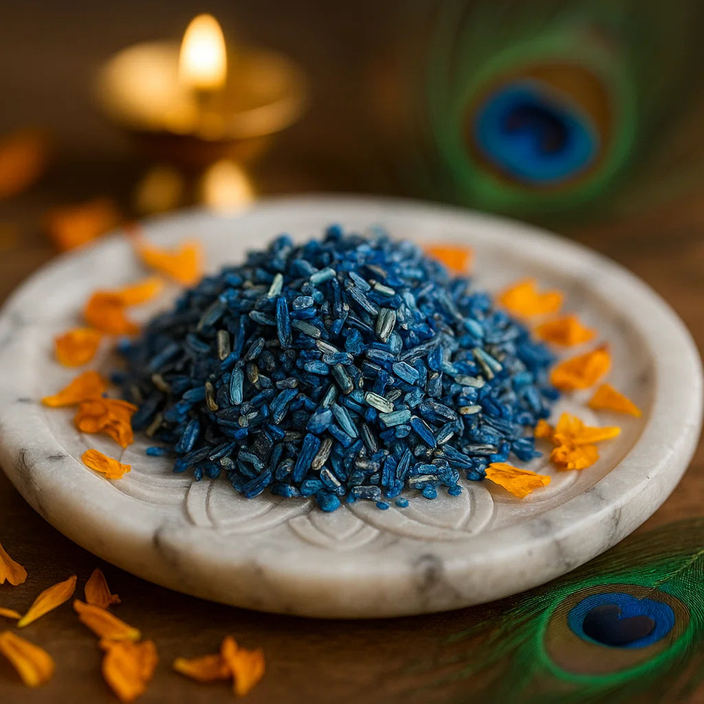 Kyanite Chips on a white plate with peacock feathers and a candle in the background