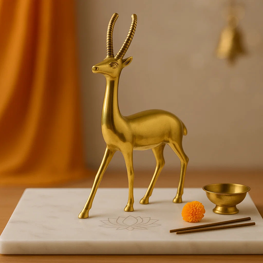 Gold deer figurine on a marble surface with a blurred background