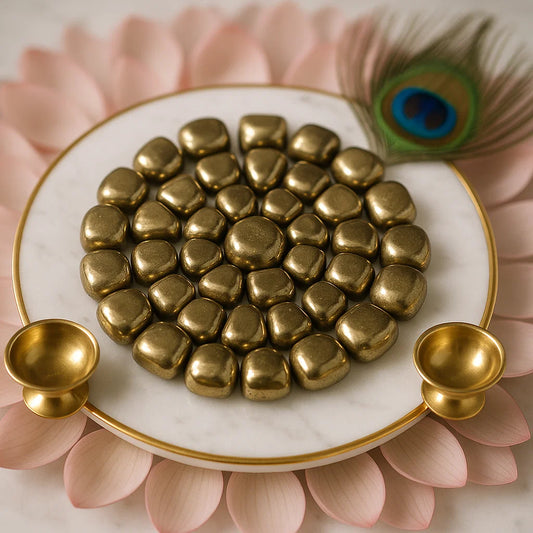 Gold stones on a white plate with gold handles, set against a pink floral background.