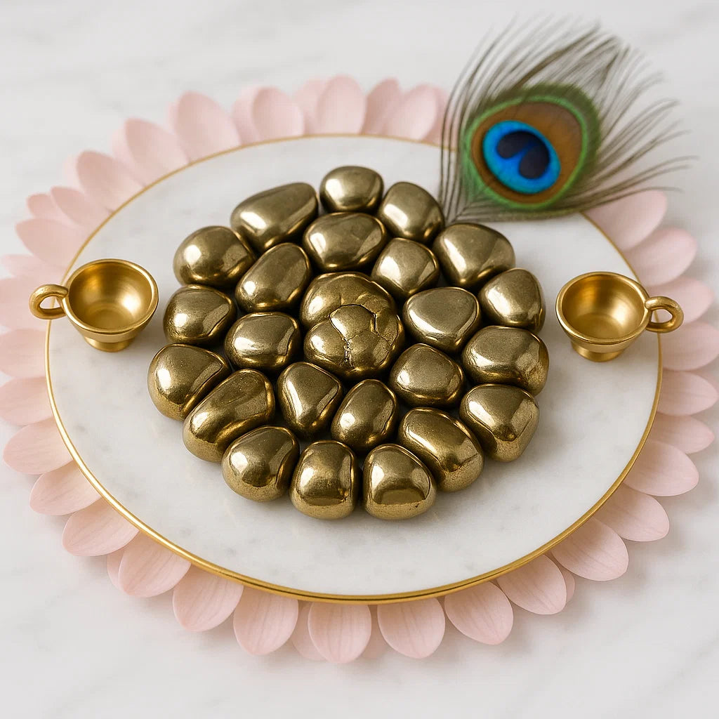 Gold heart-shaped objects on a marble plate with peacock feather