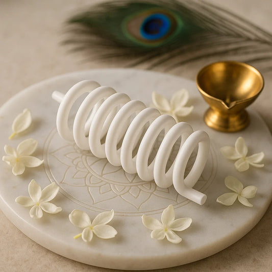 White Vastu energy correction spring placed on sacred marble thali