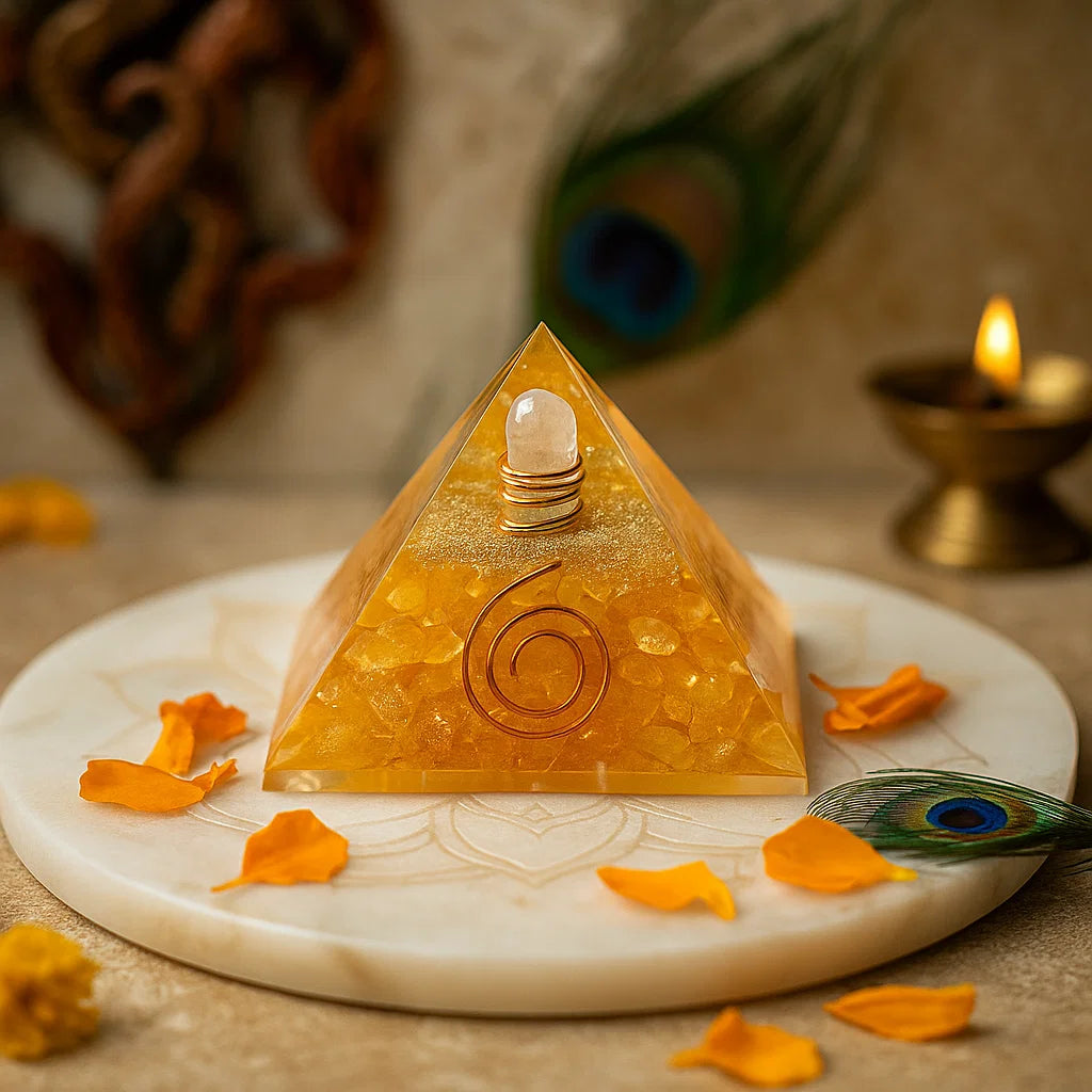 citrine orgonite vastu pyramid for wealth attraction, vastu remedy on a marble base with peacock feathers and petals.