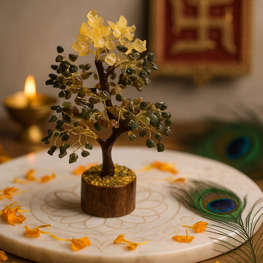 Money tree on a wooden base, surrounded by orange petals and a peacock feather on a white plate.