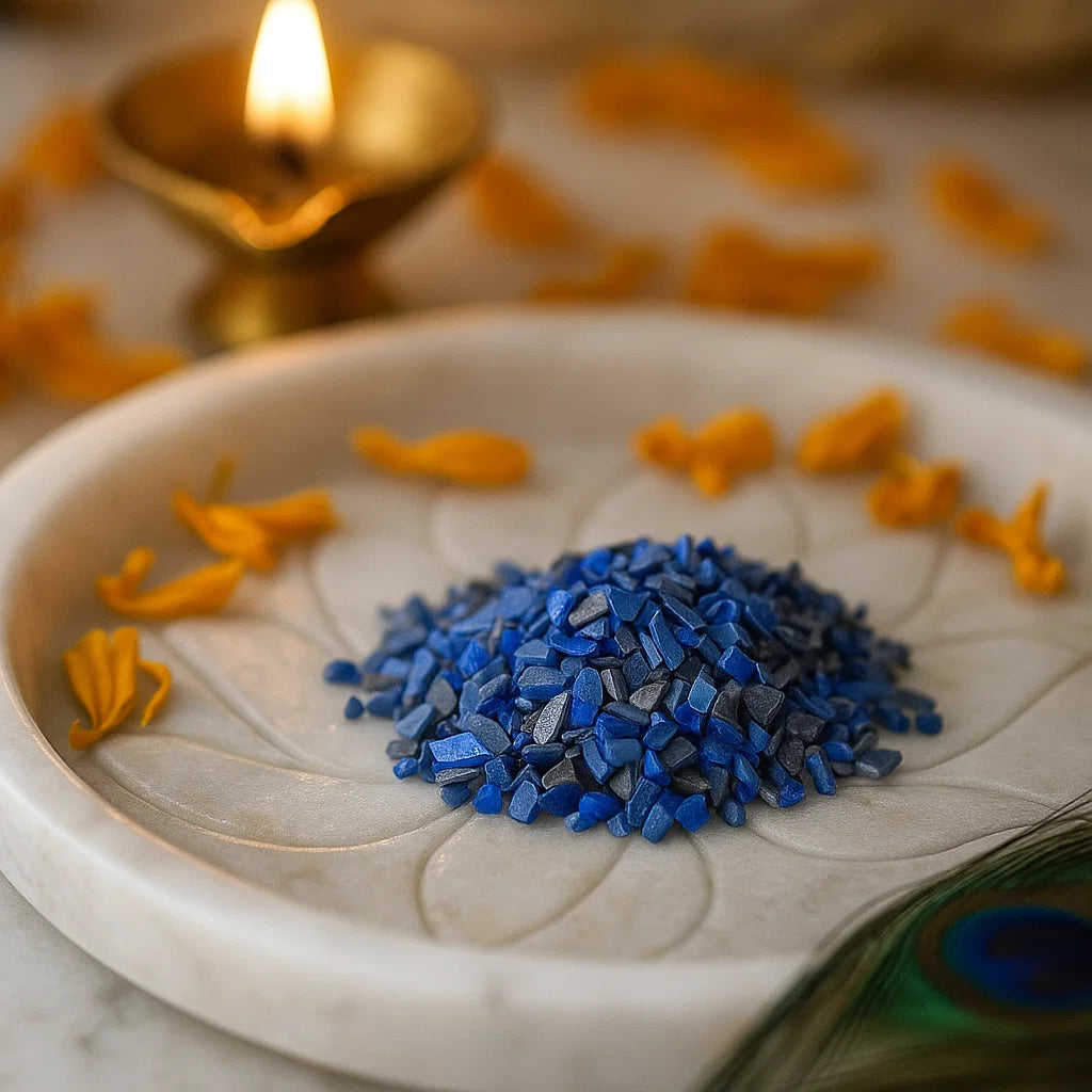 Blue Opal Vastu Dust Remedies on a white plate with yellow petals and a candle in the background