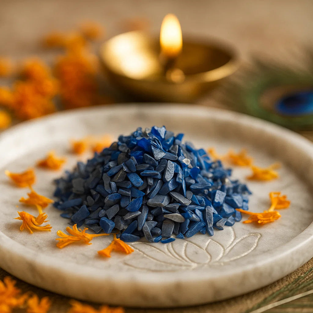 Blue Opal Vastu Dust Remedies on a white plate with a blurred candle in the background