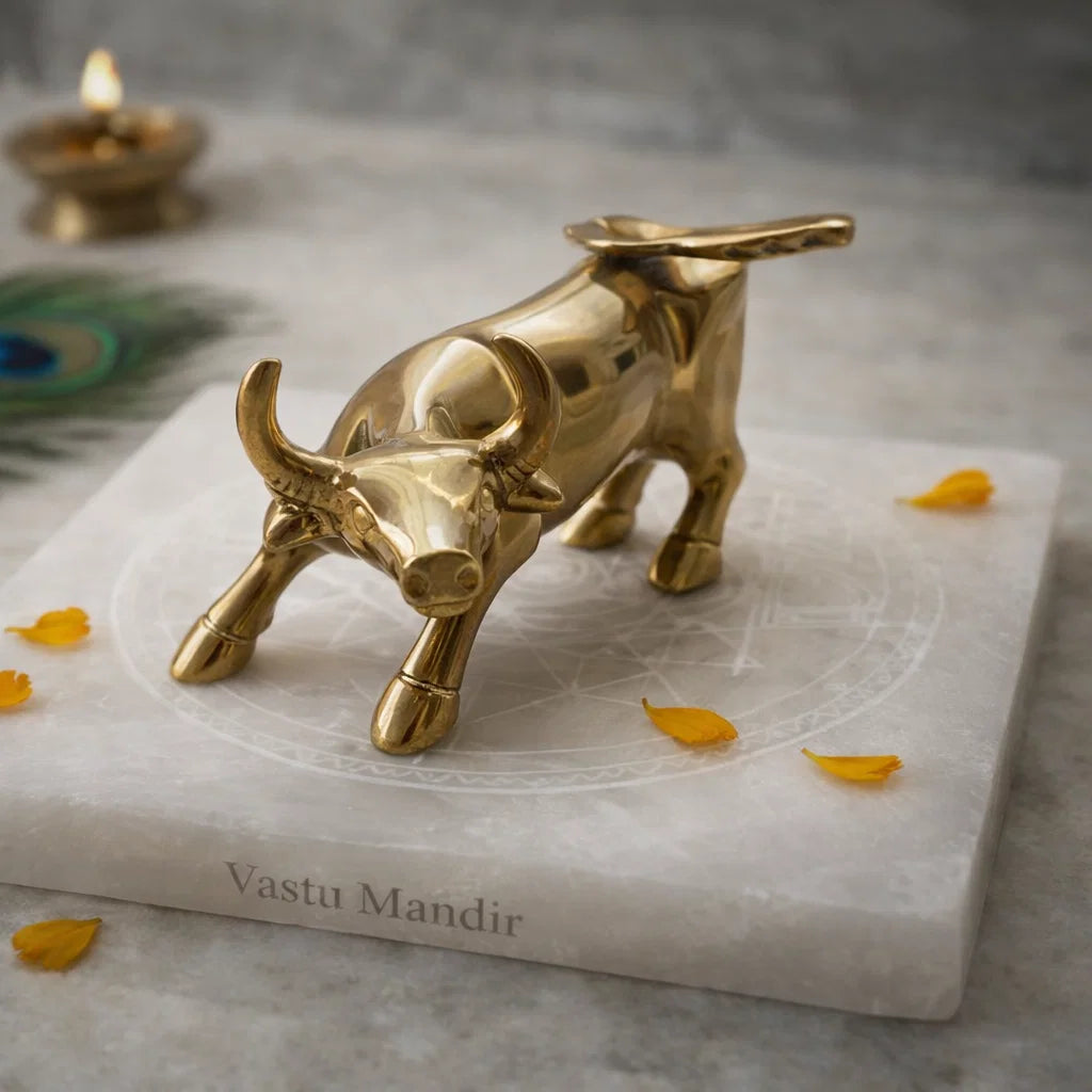 Brass bull figurine on a Selenite slab with 'Vastu Mandir' branding with decorative elements.